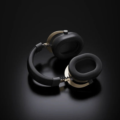 Black and gold gaming headset with plush earcups on dark background, ideal for immersive audio