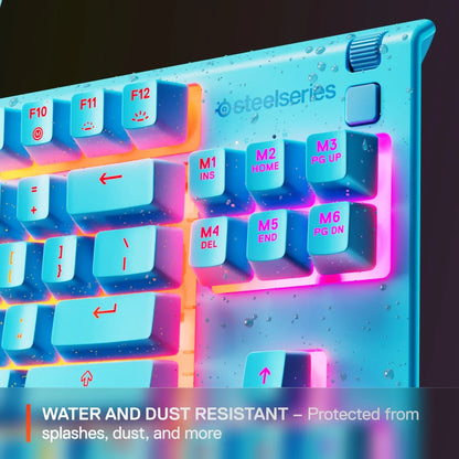 Close-up of blue SteelSeries gaming keyboard with water droplets and pink backlight, showing water and dust resistance