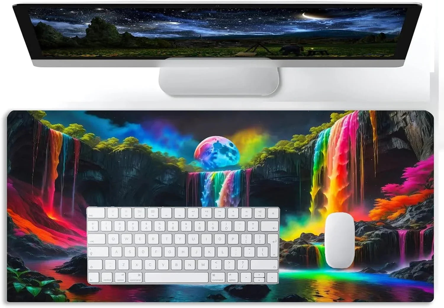 Gaming desk setup with colorful fantasy waterfall desk mat, white keyboard, mouse, and widescreen monitor with night sky
