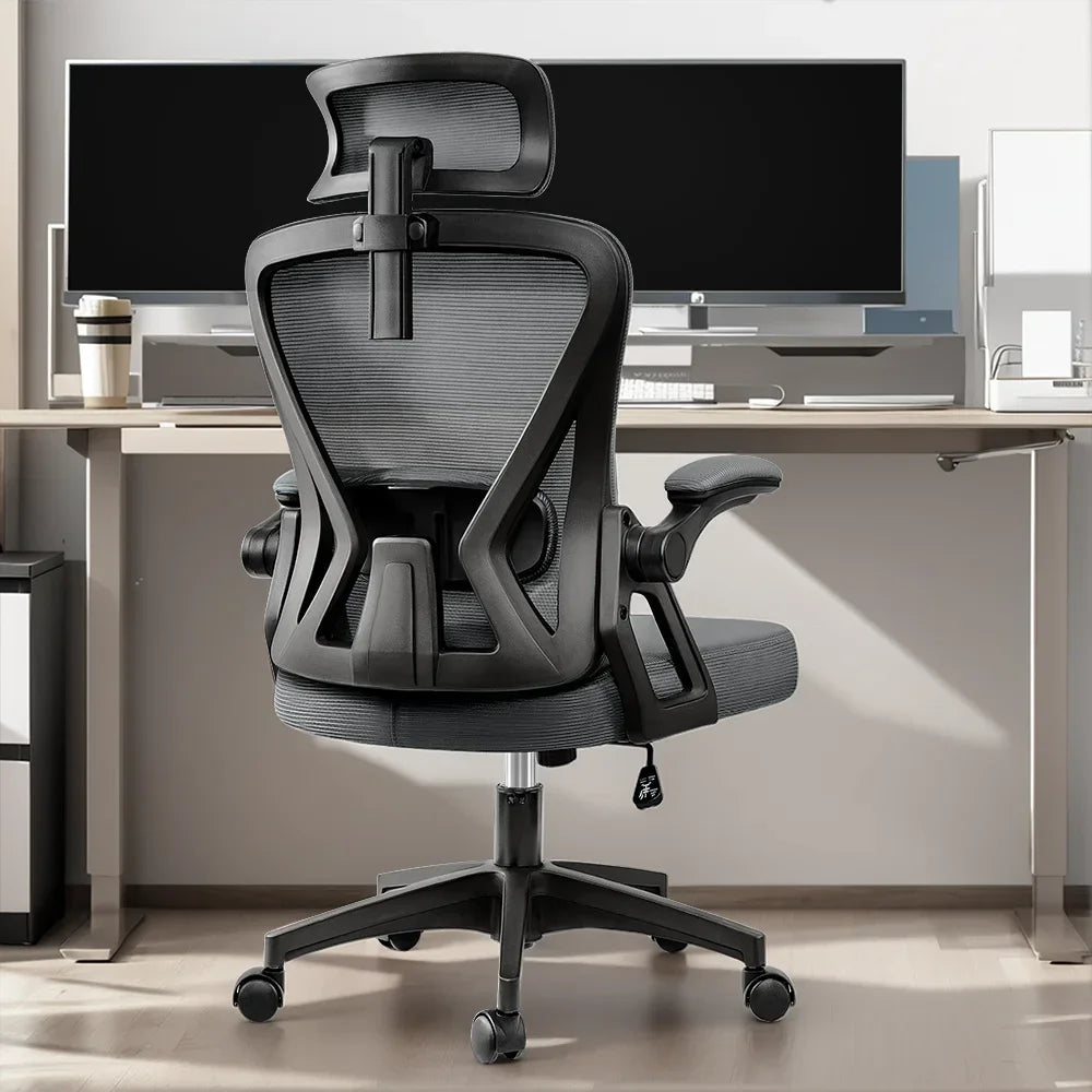 Ergonomic gaming office chair with mesh back, adjustable headrest, and armrests at modern desk setup