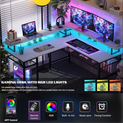 Modern L-shaped gaming desk with RGB LED lights, dual monitors, laptop, keyboard, and gaming accessories