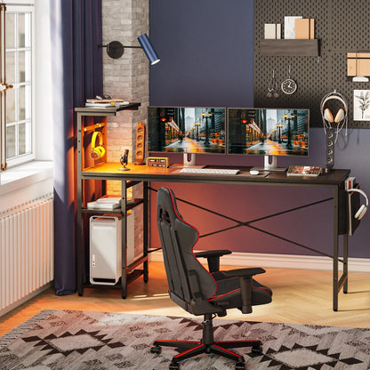 Modern gaming desk setup with dual monitors, black and red ergonomic chair, and warm LED lighting