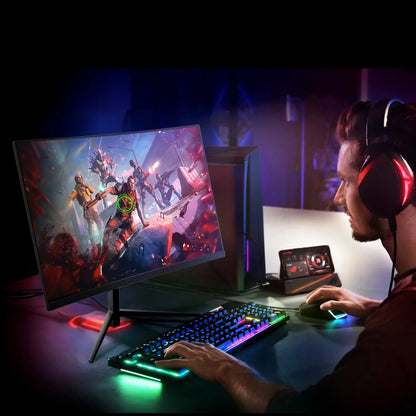 Gamer with RGB headset playing action game on curved monitor with RGB keyboard and gaming PC