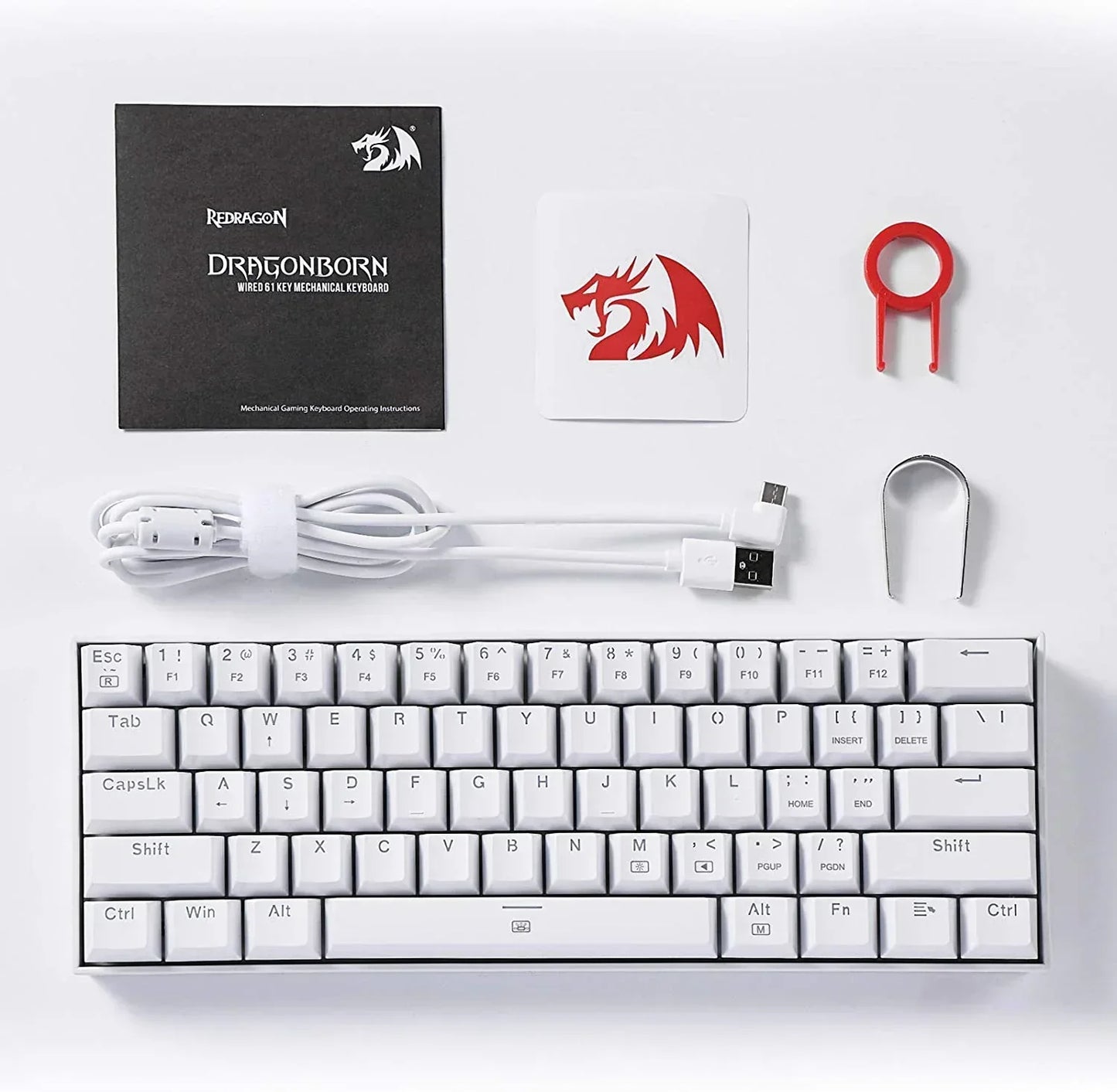 White Redragon Dragonborn 61-key mechanical gaming keyboard set with USB cable, keycap pullers, and logo sticker on a white background.