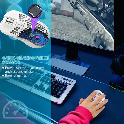 White honeycomb gaming mouse with optical sensor on RGB keyboard setup, FPS game displayed on monitor.