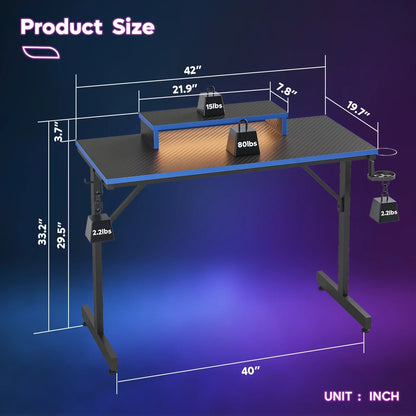 Black gaming desk with carbon fiber texture, blue trim, metal frame, and dimensions in inches