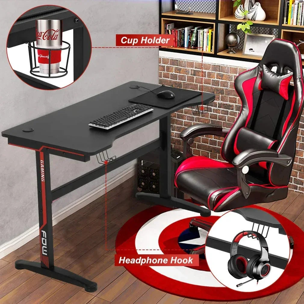 Black gaming desk with cup holder and headphone hook, paired with black and red gaming chair on round shield rug