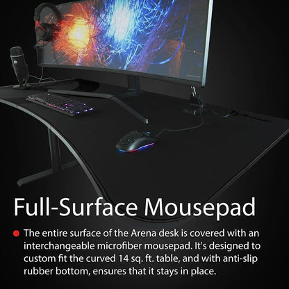 Curved gaming desk with full-surface microfiber mousepad, RGB mouse, keyboard, headset, and monitor