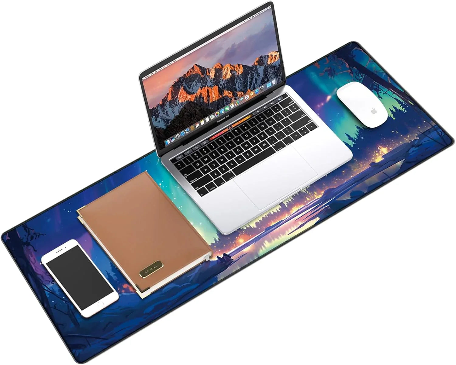 Desk setup with a colorful gaming mouse pad featuring a forest campfire scene, a laptop, white mouse, smartphone, and brown notebook
