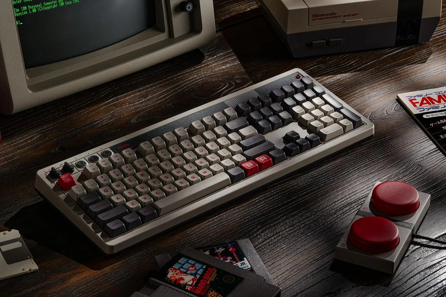 Retro 8-bit gaming mechanical keyboard with vintage PC, NES console, and game cartridges.