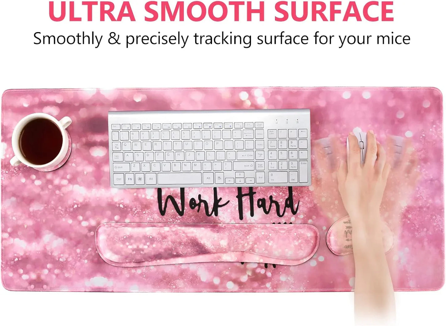 Pink ultra smooth gaming mousepad with wrist rest, white keyboard, coffee cup, and hand using mouse