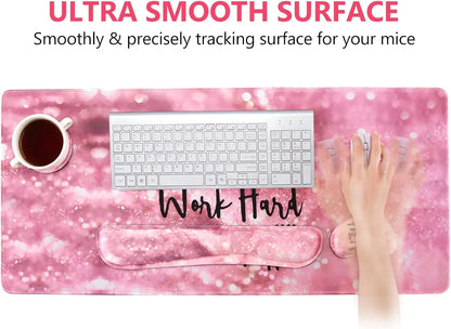 Pink ultra smooth gaming mousepad with wrist rest, white keyboard, coffee cup, and hand using mouse