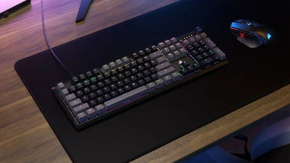 RGB mechanical gaming keyboard and mouse on a black desk mat, modern gaming setup