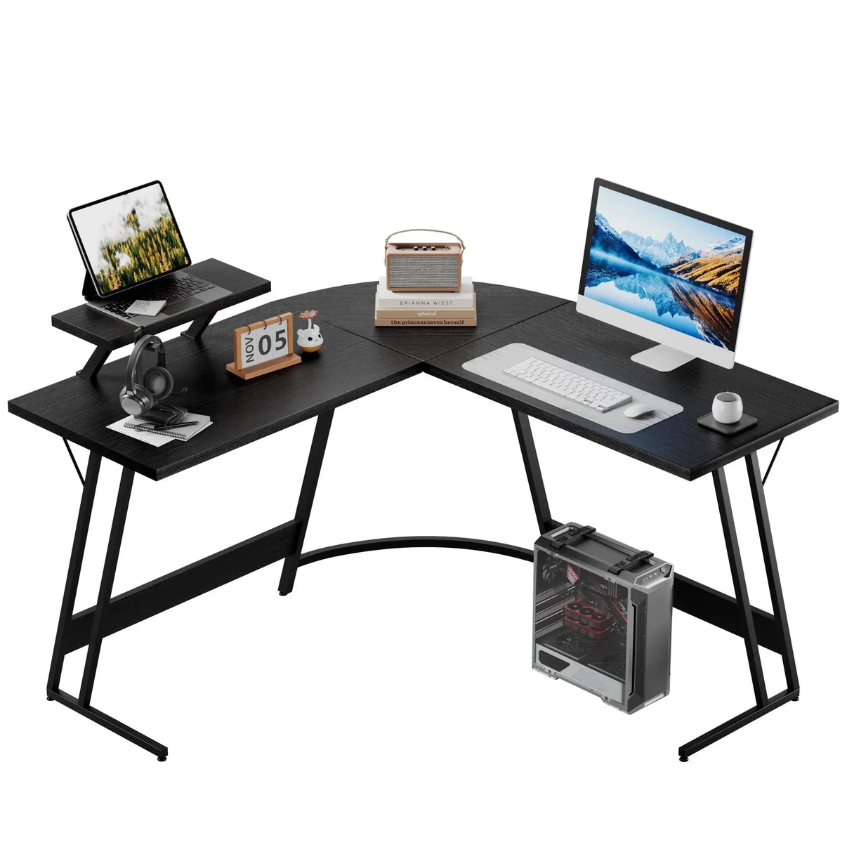 Modern black L-shaped computer desk with monitor, tablet, keyboard, mouse, headphones, calendar, and desktop PC