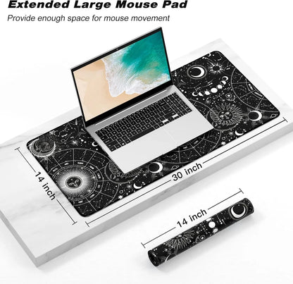 Extended large black mouse pad with celestial sun, moon, and constellation designs under silver laptop, 30x14 inch size
