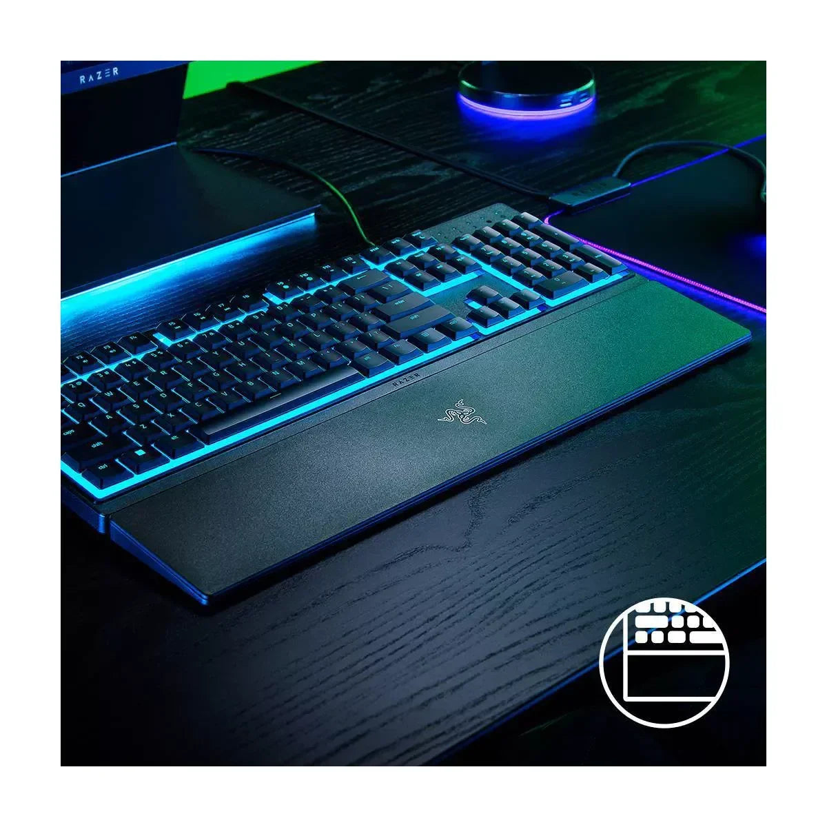 RGB backlit gaming keyboard with wrist rest on black desk at Byte Style