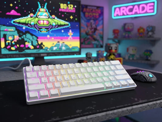 RGB mechanical keyboard on gaming desk with 8-bit arcade setup and pixel art decor