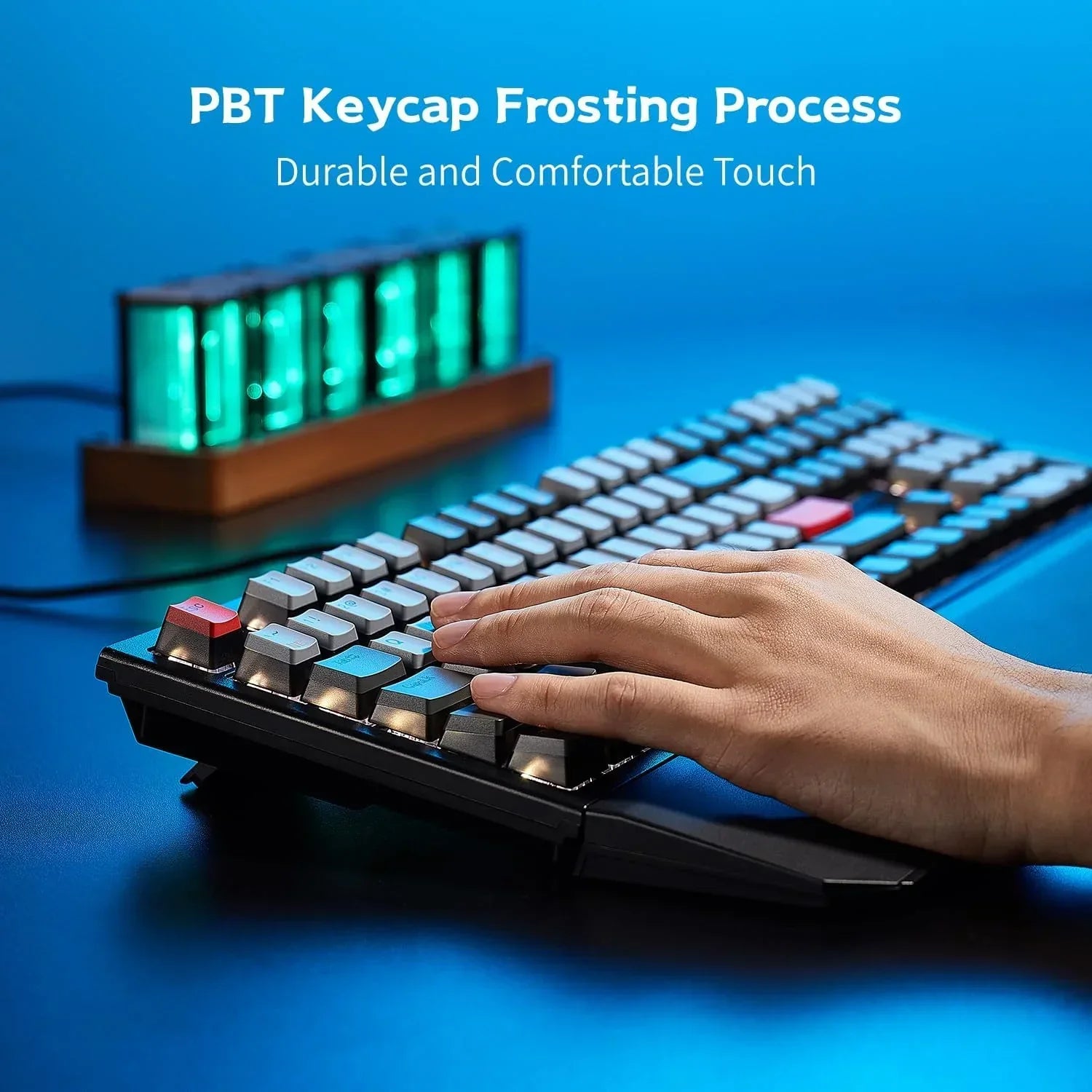 Hand typing on retro-style mechanical keyboard with PBT keycaps and RGB lighting on desk