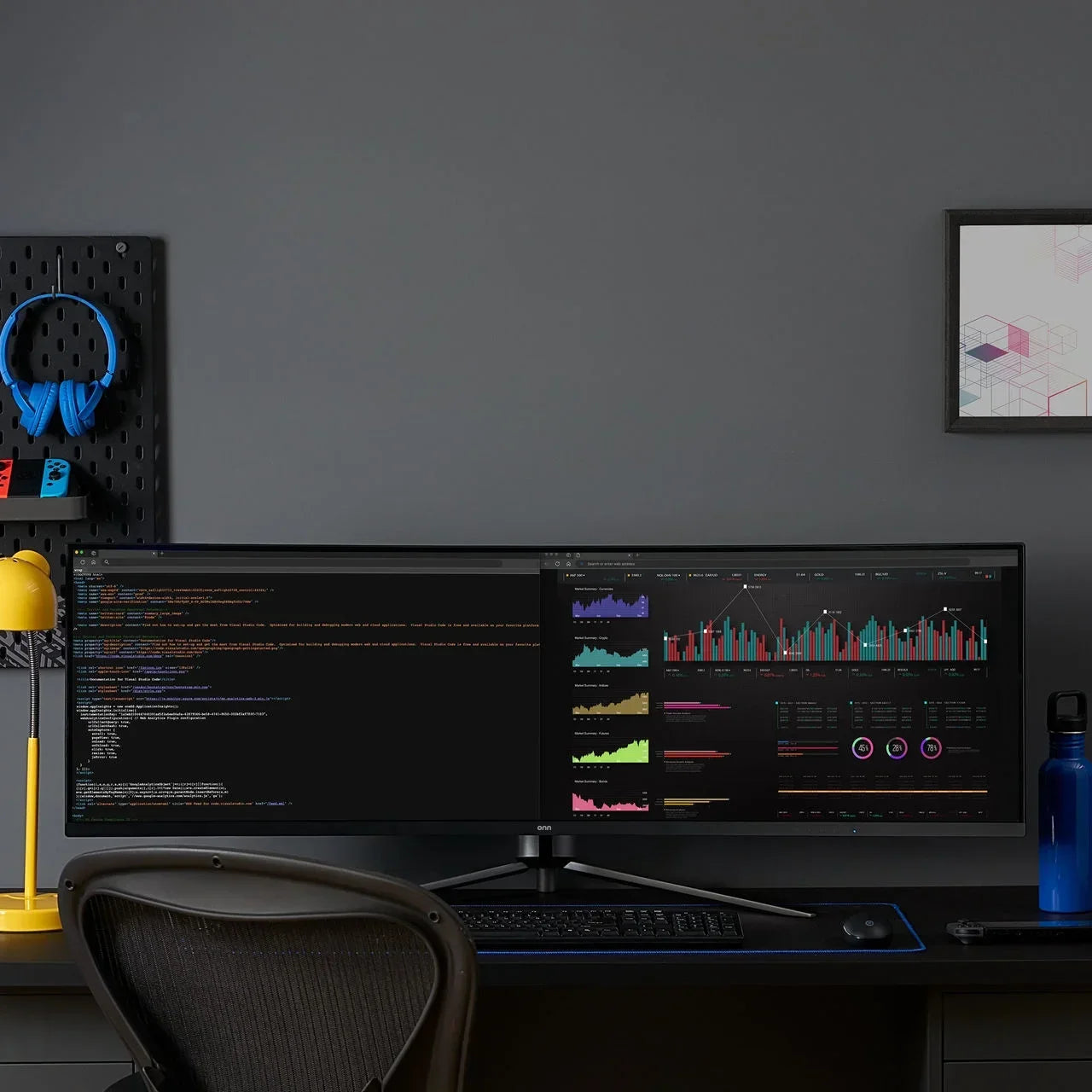 Ultra-wide curved monitor on black desk showing coding and data charts, with yellow lamp, blue headphones, and gaming gear