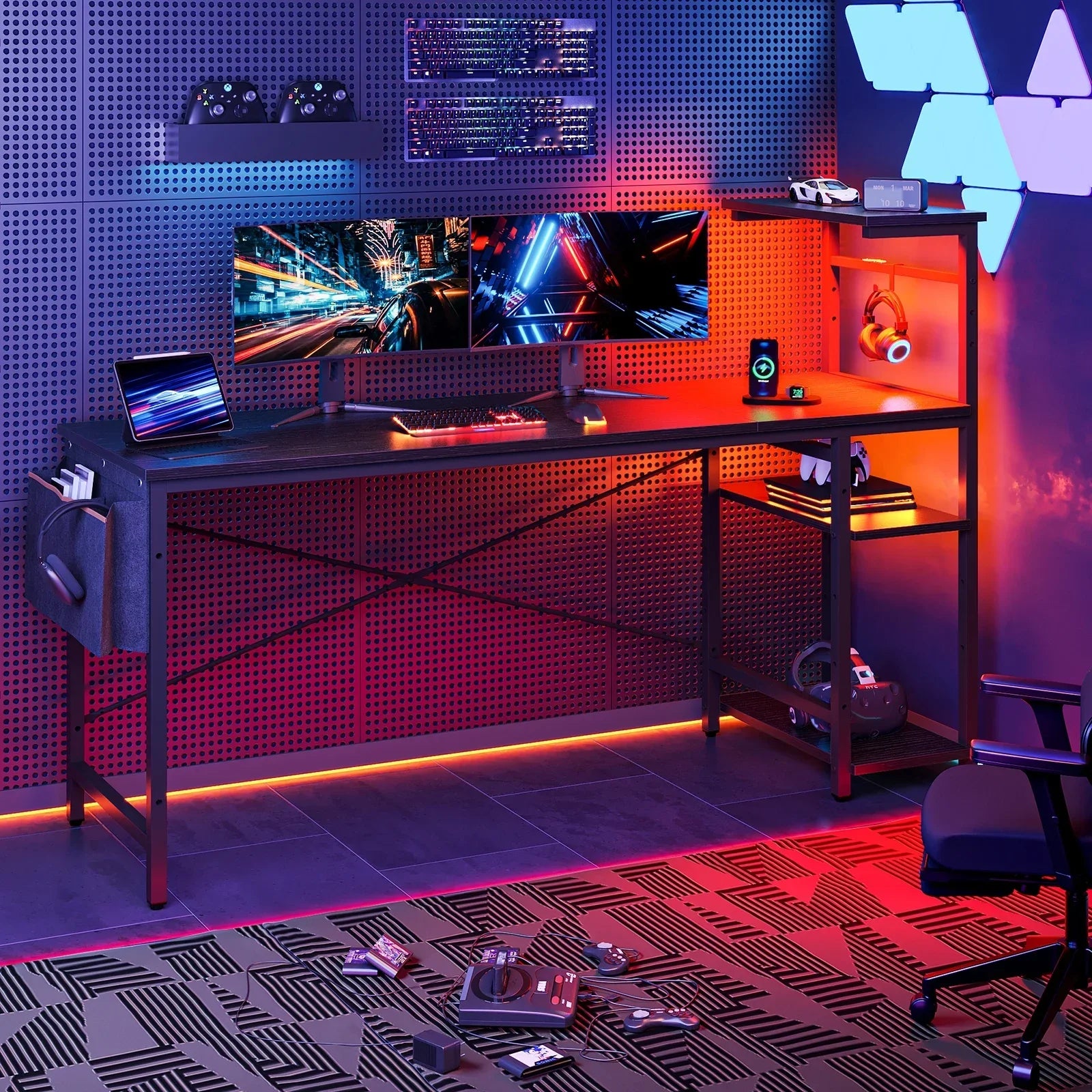 Modern gaming desk setup with dual monitors, RGB keyboard, gaming controllers, and ambient LED lighting