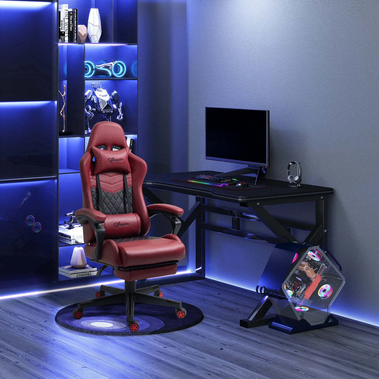 Modern gaming setup with red ergonomic gaming chair, black desk, RGB keyboard and mouse, angled PC case with RGB fans, and blue ambient lighting