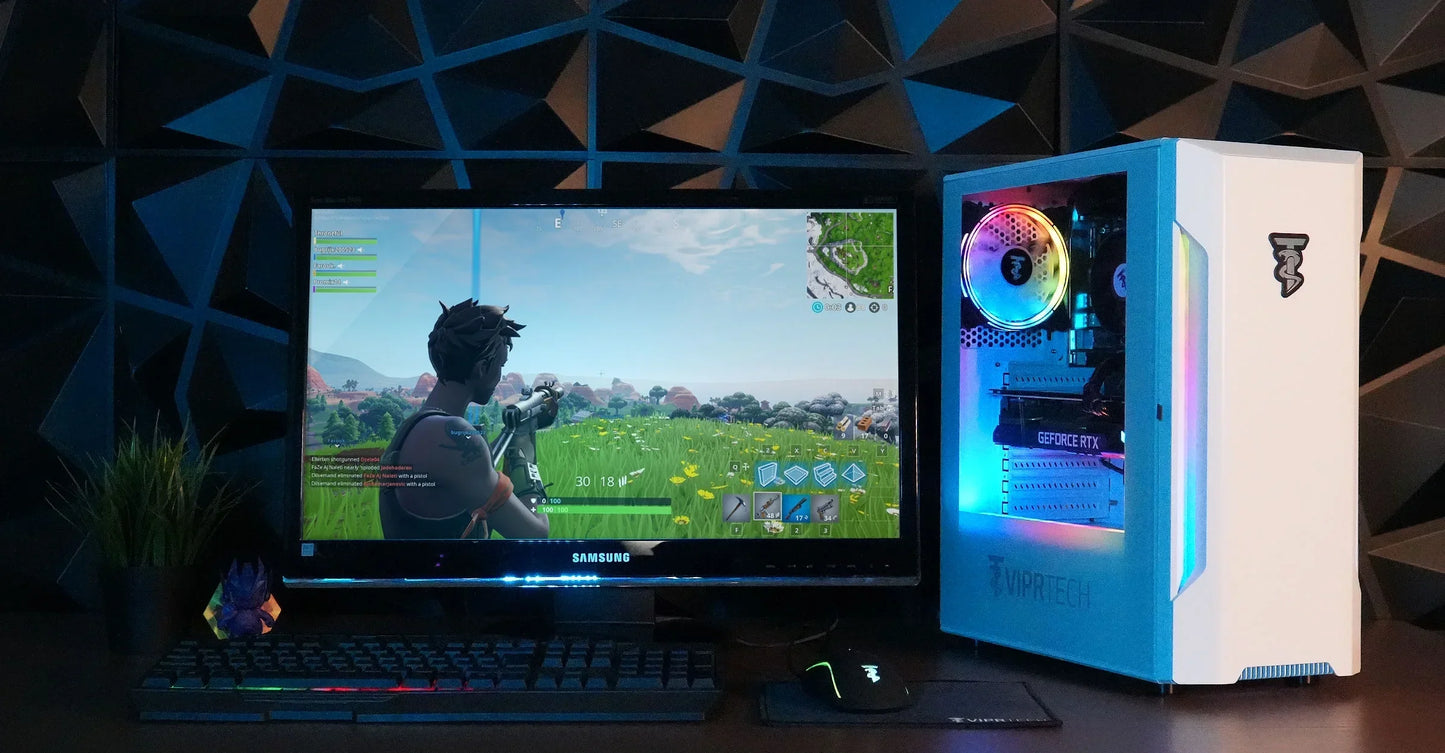 Gaming setup with Samsung monitor displaying Fortnite, RGB mechanical keyboard, mouse, and VIPRTECH PC tower with colorful LED lights