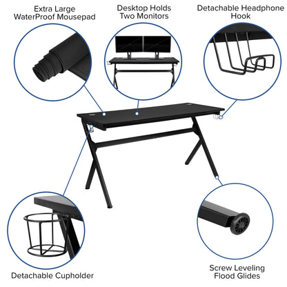 Black gaming desk with waterproof mousepad, dual monitor setup, detachable cupholder, headphone hook, and leveling feet