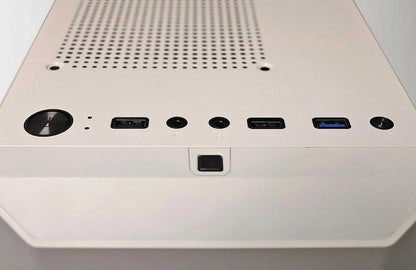 Close-up of white PC case top panel with power button, USB ports, headphone and microphone jacks