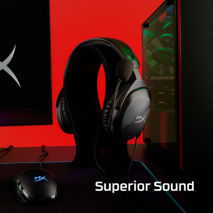 HyperX gaming headset with microphone on stand next to gaming mouse and PC tower with red background