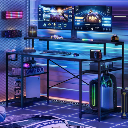 Modern gaming setup with dual monitors, RGB keyboard, mouse, Nintendo Switch, and Alienware desktop tower
