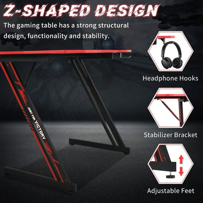 Z-shaped gaming desk with red and black design, headphone hooks, stabilizer bracket, and adjustable feet