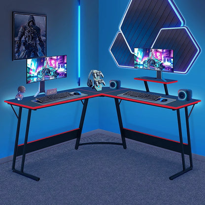 Modern dual-monitor L-shaped gaming desk setup with RGB lighting and gaming accessories