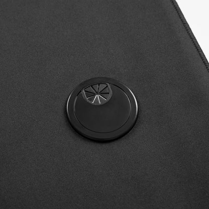 Black fabric with a circular black cable grommet featuring a twist-open flap