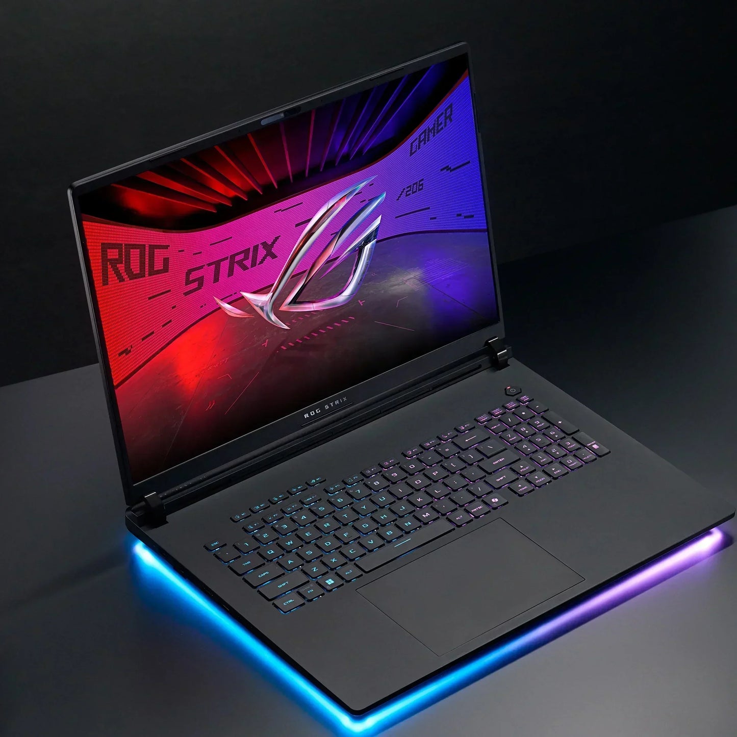 RGB backlit gaming laptop with illuminated keyboard and glowing edge, ROG Strix screen