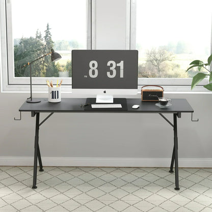 Minimalist black office desk with iMac, desk lamp, pencil holder, coffee cup, and speaker by window with forest view