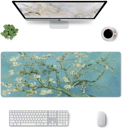 Wide desk mouse pad with Vincent van Gogh's almond blossom design, white keyboard, mouse, iMac, plant, and coffee cup