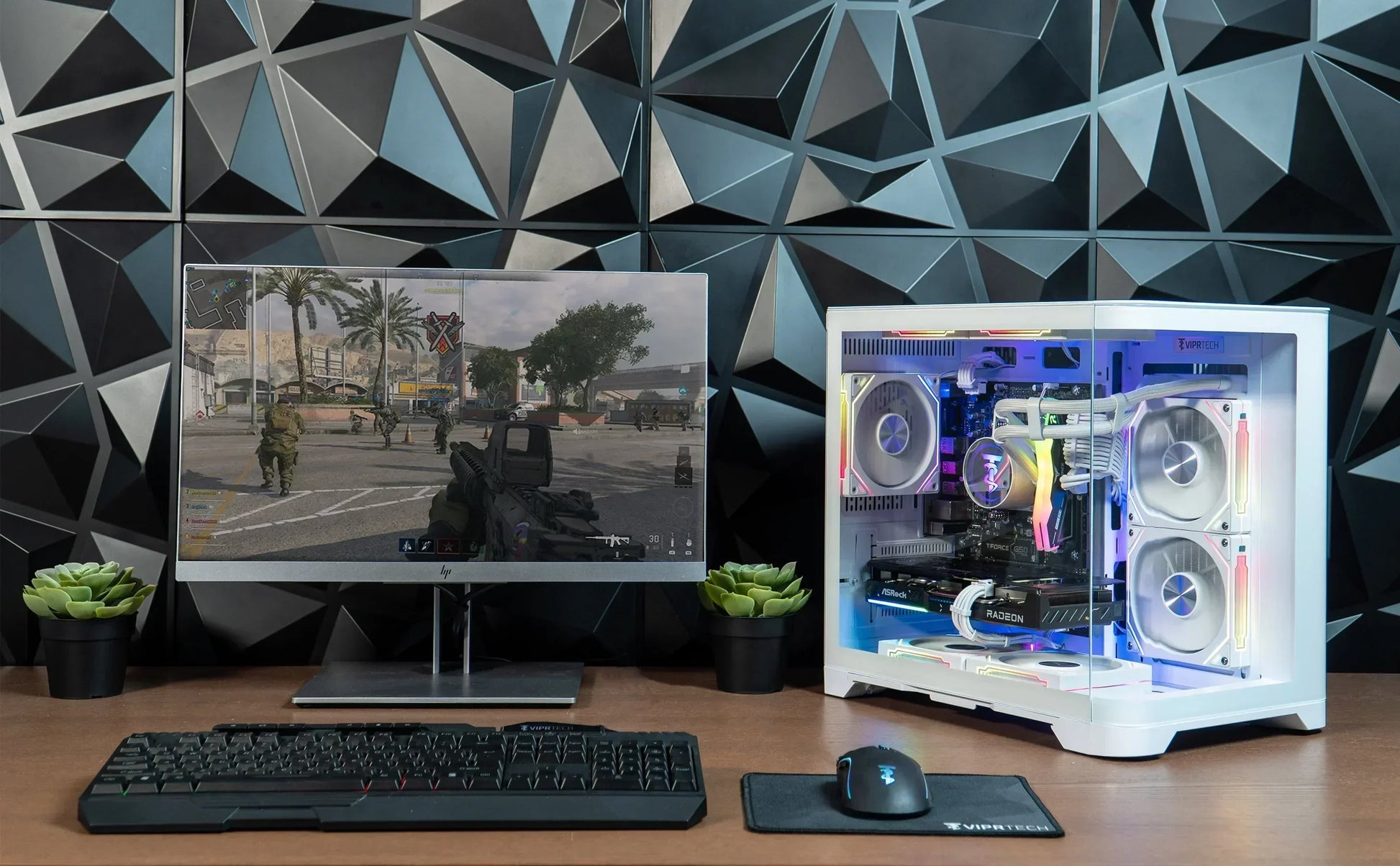 Modern gaming PC setup with RGB desktop, mechanical keyboard, mouse, and monitor on desk