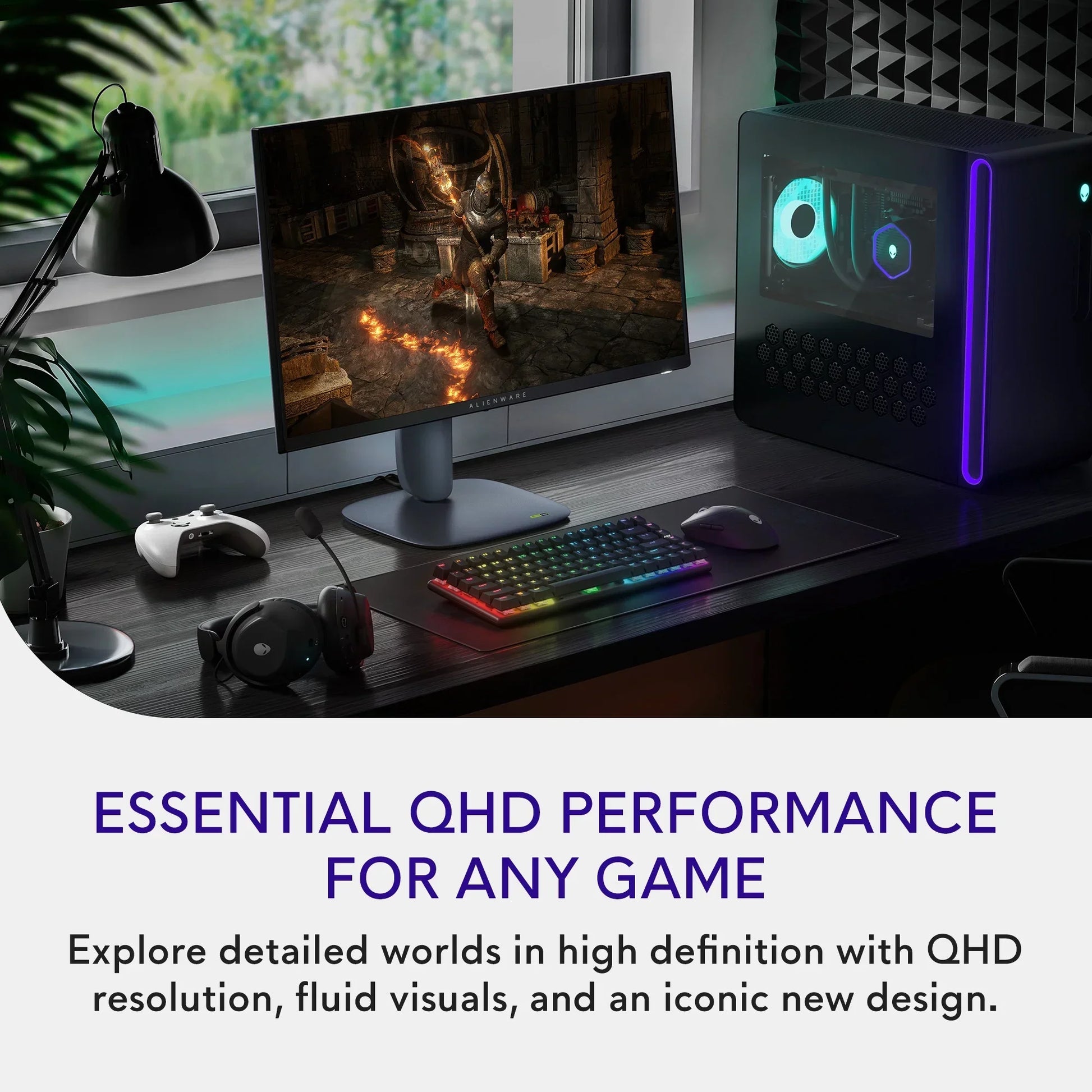 Gaming setup with Alienware QHD monitor displaying a medieval knight game, RGB keyboard, mouse, headset, and PC tower