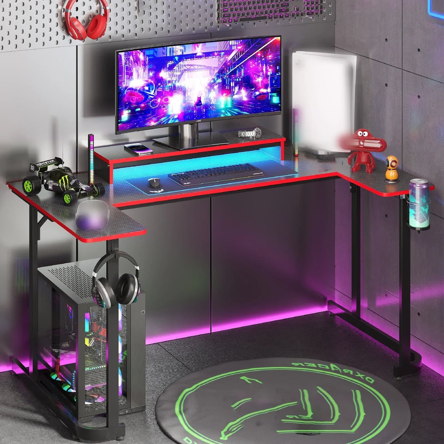 L-shaped gaming desk with RGB lighting, curved monitor, gaming keyboard, PC tower, and headphones