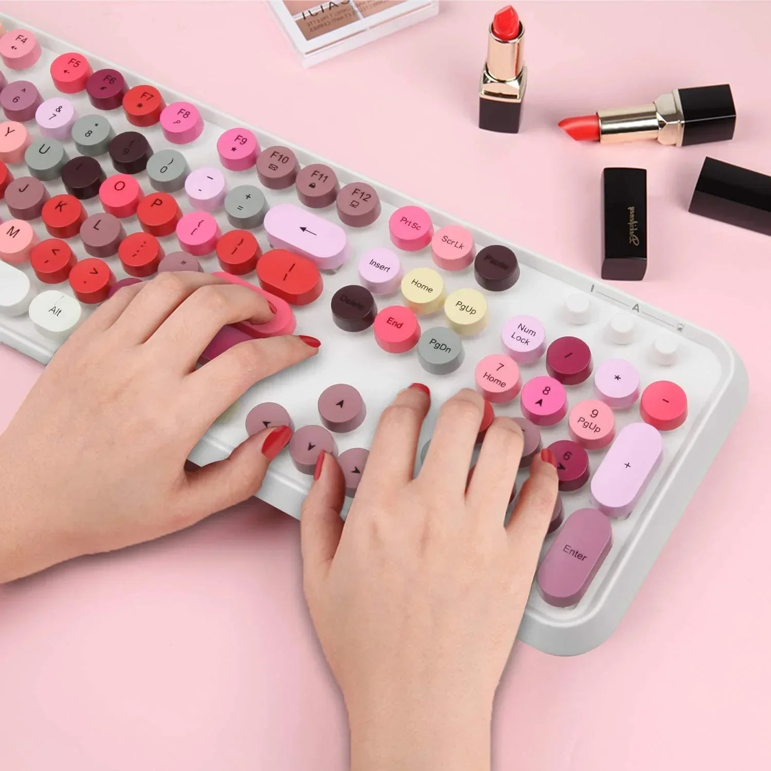 Hands typing on pastel pink retro 8-bit style mechanical keyboard with lipstick, modern gaming gear
