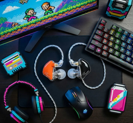 Retro gaming setup with RGB keyboard, pixel headphones, monitor showing 8-bit game, and colorful in-ear monitors.