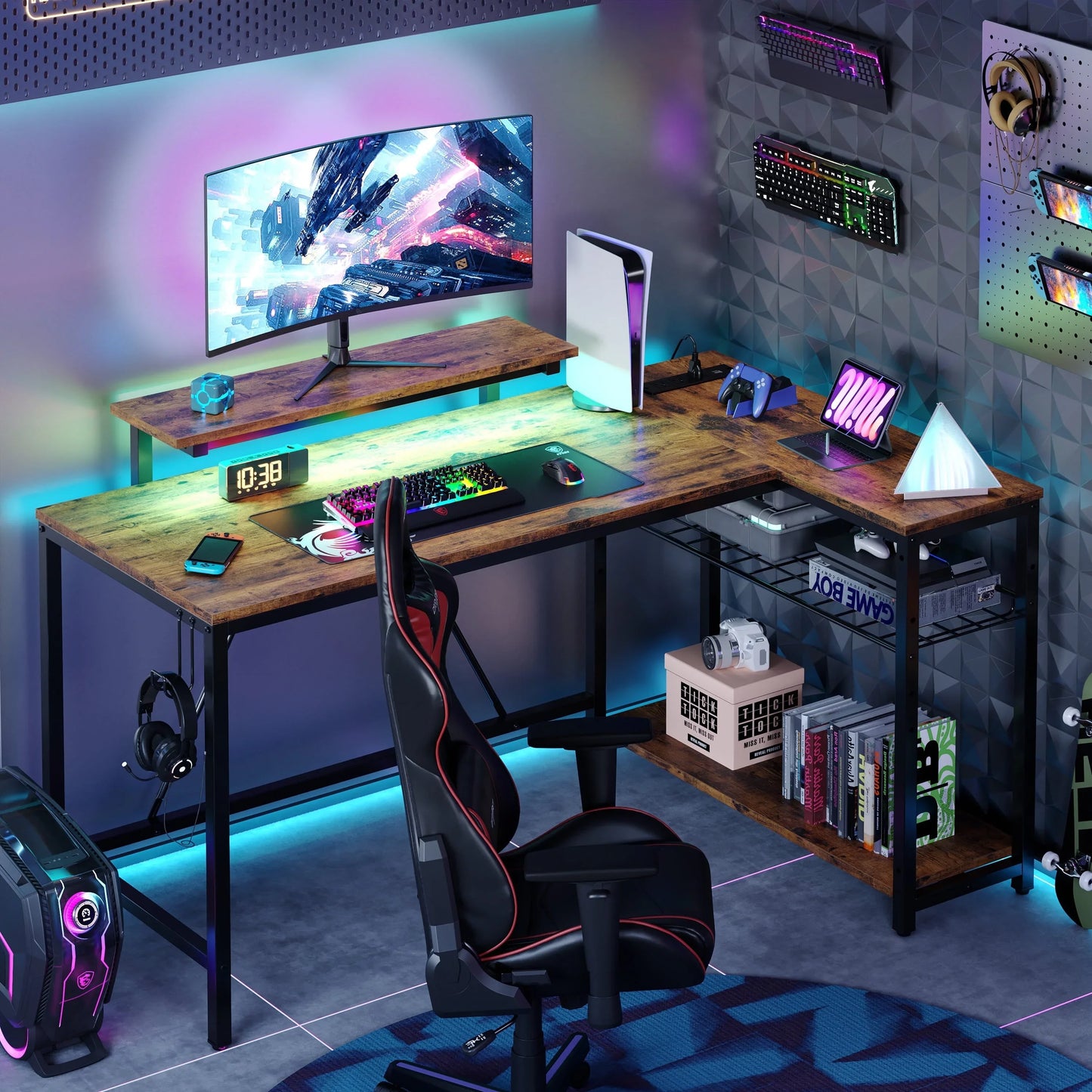 Modern gaming setup with curved monitor, colorful RGB keyboard, PS5, black gaming chair, and wood desk