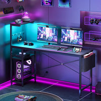 Modern dual monitor gaming setup with RGB lighting, sleek black desk, gaming PC and controllers