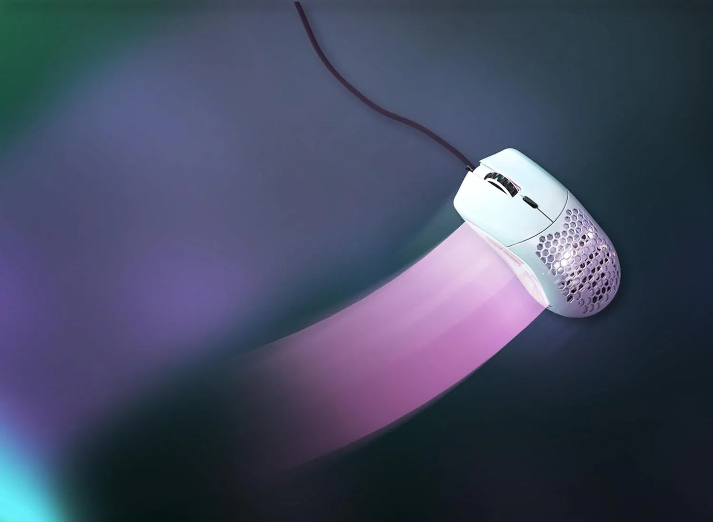 White wired gaming mouse with honeycomb design on dark glowing surface with pink trail effect