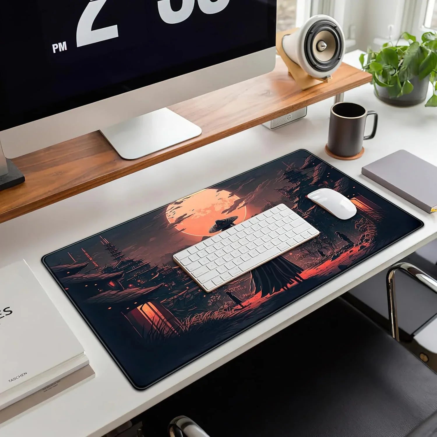 Modern desk setup with white keyboard and mouse on a large gaming mouse pad featuring a dark samurai landscape under an orange full moon