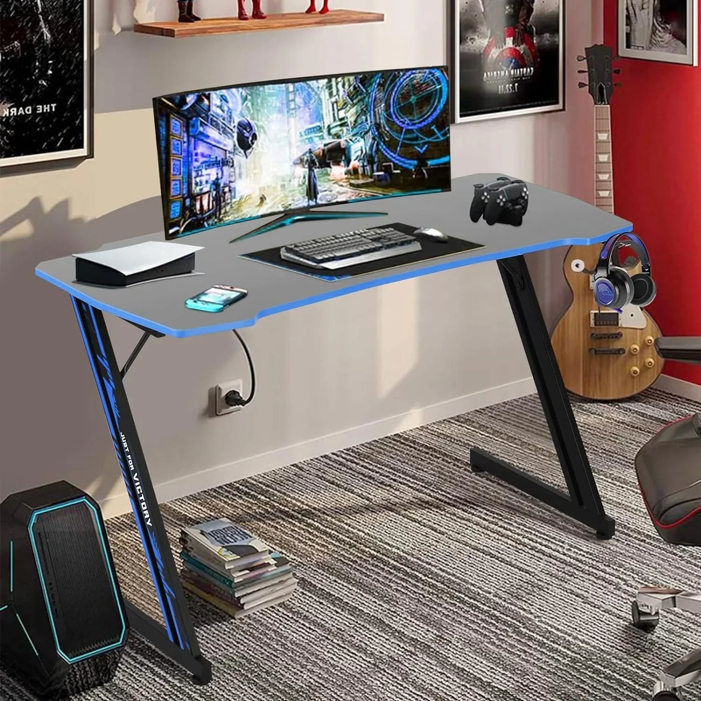 Modern gaming desk setup with curved widescreen monitor, keyboard, mouse, game controllers, and console in a stylish room