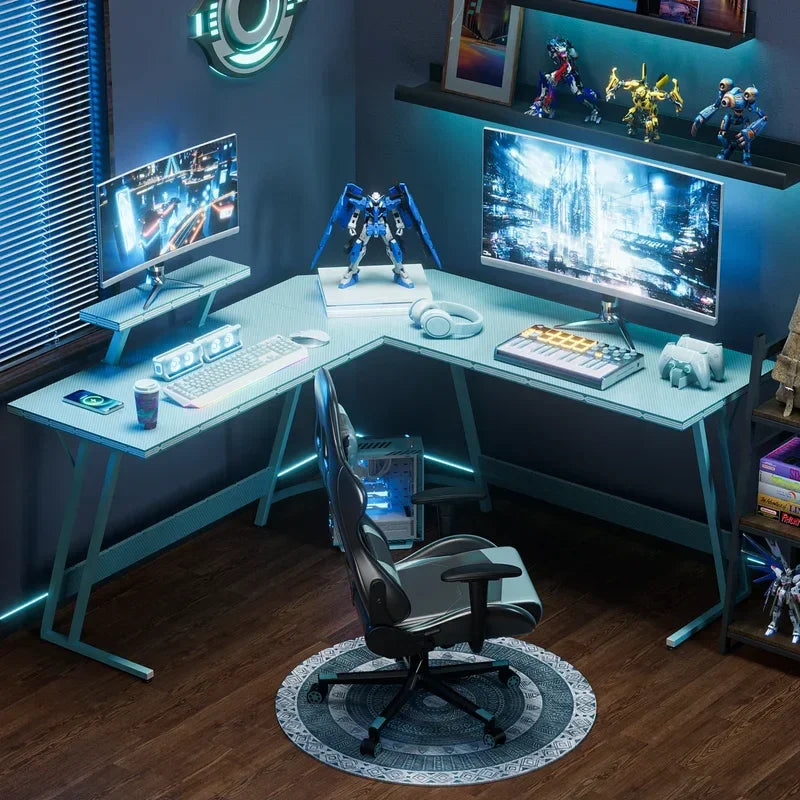 Modern gaming and music production desk setup with dual monitors, keyboard, headphones, and robot figurines