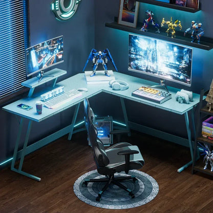 Modern gaming and music production desk setup with dual monitors, keyboard, headphones, and robot figurines