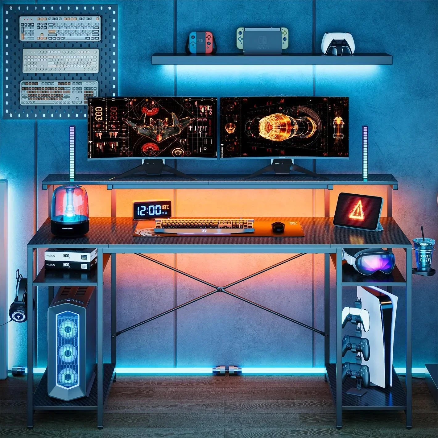 Modern gaming setup with dual monitors, mechanical keyboard, gaming PC, PlayStation 5, controllers, and LED lighting