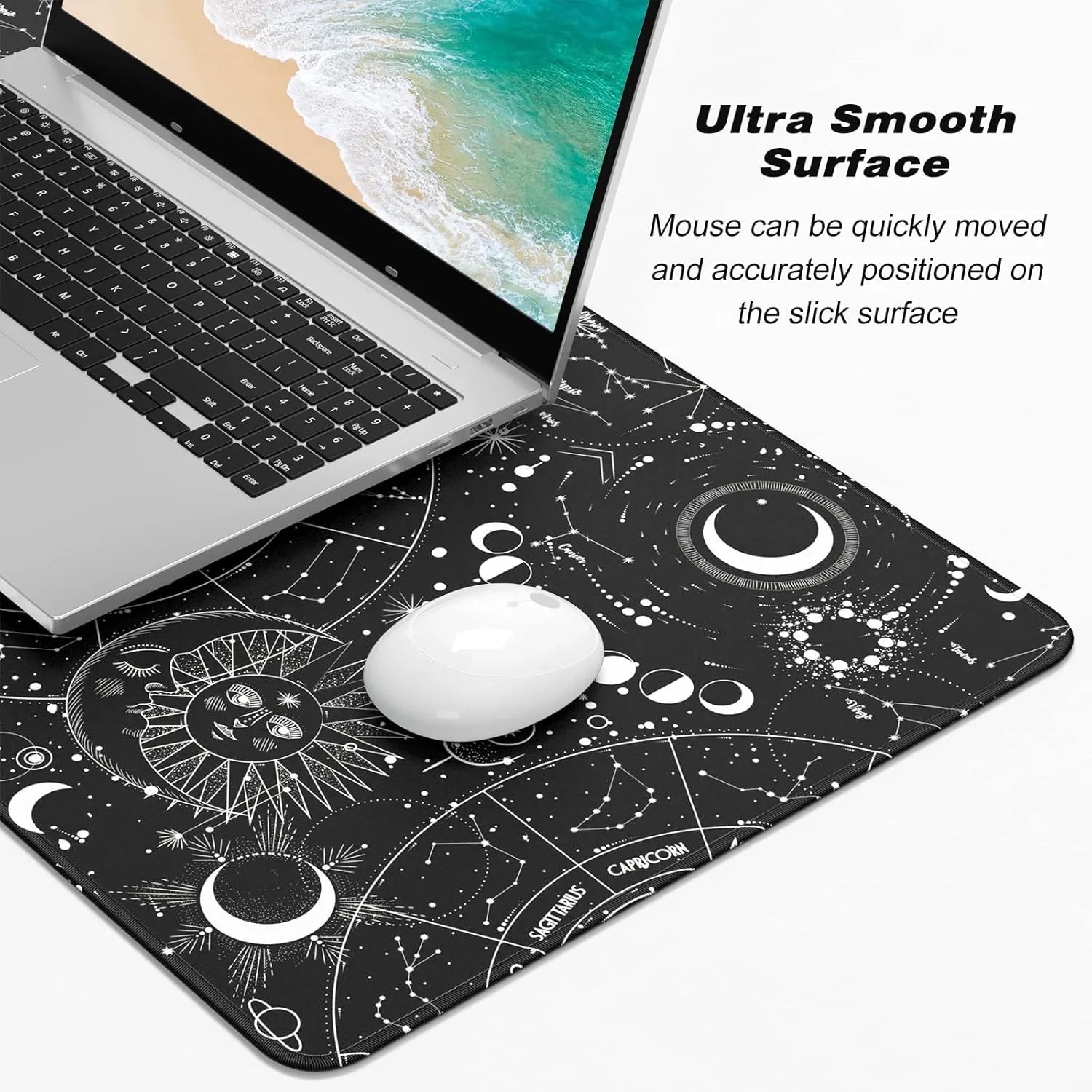 Black space-themed mouse pad with zodiac constellation designs under a laptop and white mouse, highlighting ultra smooth surface